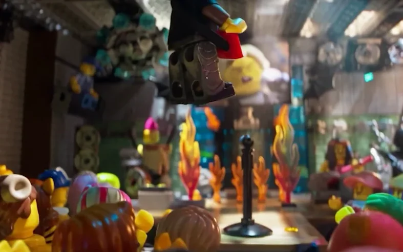 A minifigure mid stage-dive above a packed crowd of minifigures, still gripping its red keytar