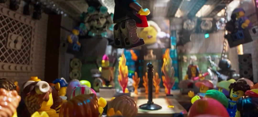 A minifigure mid stage-dive above a packed crowd of minifigures, still gripping its red keytar