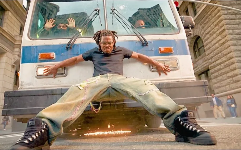 A hero braced against the front of a bus, boots throwing sparks as he stops it dead in the street
