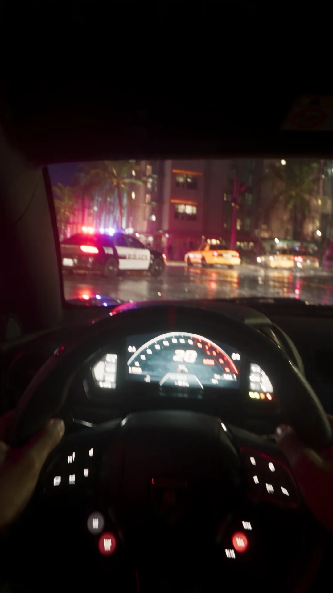 Driver's view through a supercar windscreen at night, dashboard lit, a police cruiser with flashing lights ahead on a wet palm-lined street